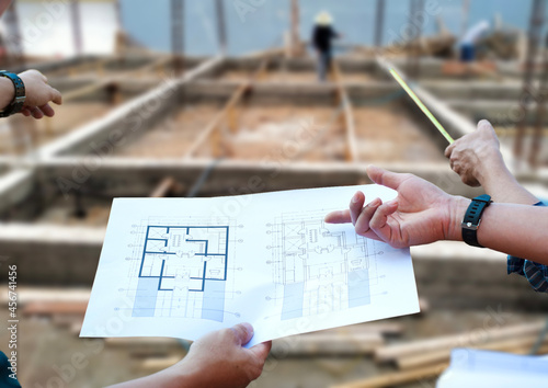 Engineers who inspect construction projects and contractors discussion and plan construction operations.