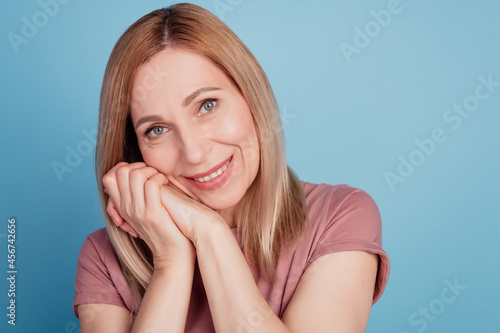 Closeup photo of attractive lady short hairdo arms hold chin smiling overjoyed isolated blue color background