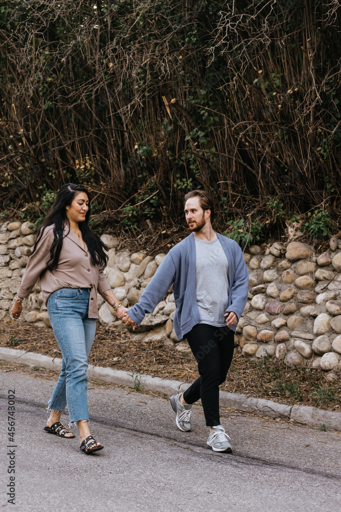 Obraz premium Interracial couple walking on street outside
