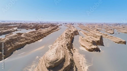 Desert landscape with bizarre rocks naturally formed by wind and rain in Dunhuang Yardang National Geopark, Gansu China. (aerial photography) photo