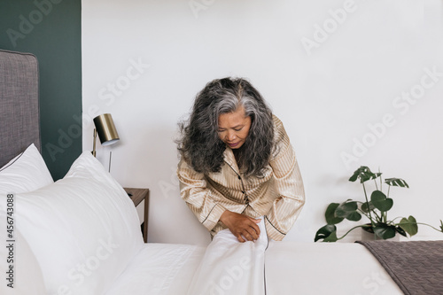 Asian woman making bed in the morning