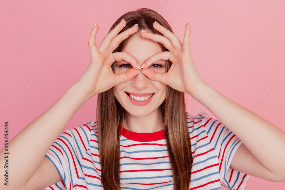Portrait of charming sweet funky lady fingers show okey sign binoculars form on pink background Portrait of charming sweet funky lady fingers show okey sign binoculars form on pink background