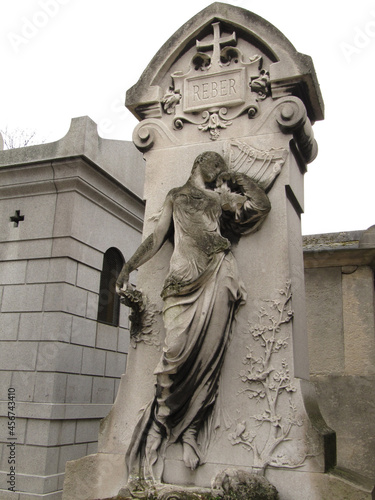 Beautiful sculpture in a stone of a tomb in the Pere Lachaise cemetery. All Saints Day, November 1, Day of the Dead, Dia de muertos.
