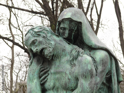 Bust detail of a bronze sculpture of Virgin Maria and Jesus Christ in the Pere Lachaise cemetery. All Saints Day, November 1, Day of the Dead, Dia de muertos.