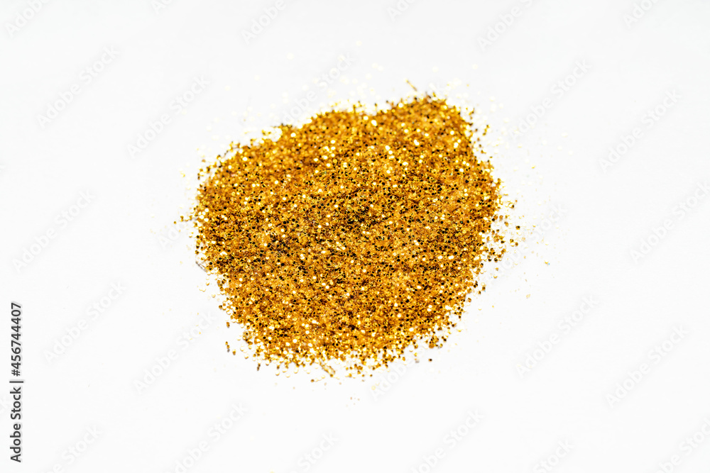 Gold sparkles on white background. Top view Gold sparkles on white background. Top view