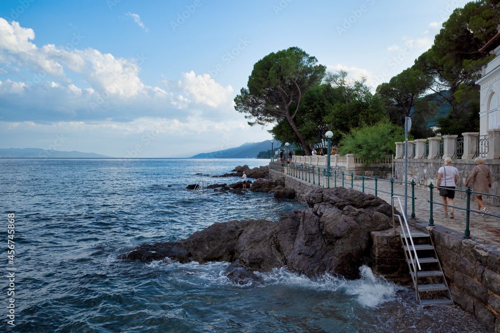 Rijeka, Croatia - August 11, 2021: Resort on the Adriatic Sea. City beaches, vegetation and buildings in Croatia. Seascape with a stone shore.