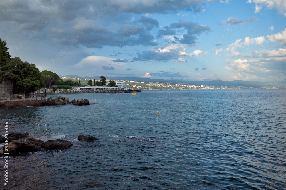 Rijeka, Croatia - August 11, 2021: Resort on the Adriatic Sea. City beaches, vegetation and buildings in Croatia. Seascape with a stone shore.