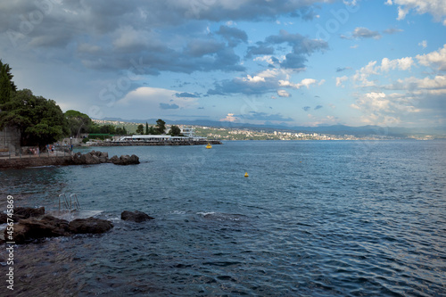 Obraz na płótnie Rijeka, Croatia - August 11, 2021: Resort on the Adriatic Sea. City beaches, vegetation and buildings in Croatia. Seascape with a stone shore. w salonie
