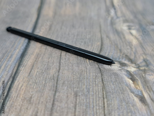 The Black stylus from a mobile device. Digital stylus close-up. photo