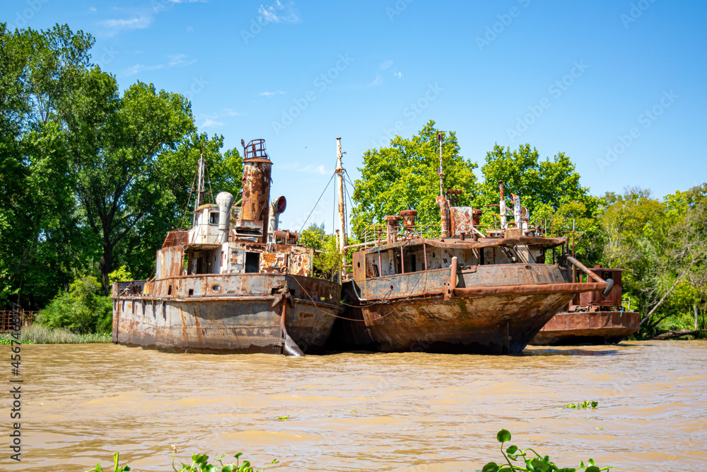 Incredible and beautiful old boats stranded at the edge of a river