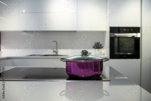 modern kitchen with a metal pot in foreground