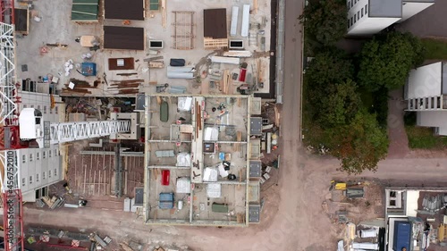Aerial view of the construction site of the apartment buildings. Flying over the tower crane