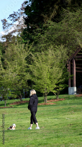 Female walking her dog outside. © oscar williams