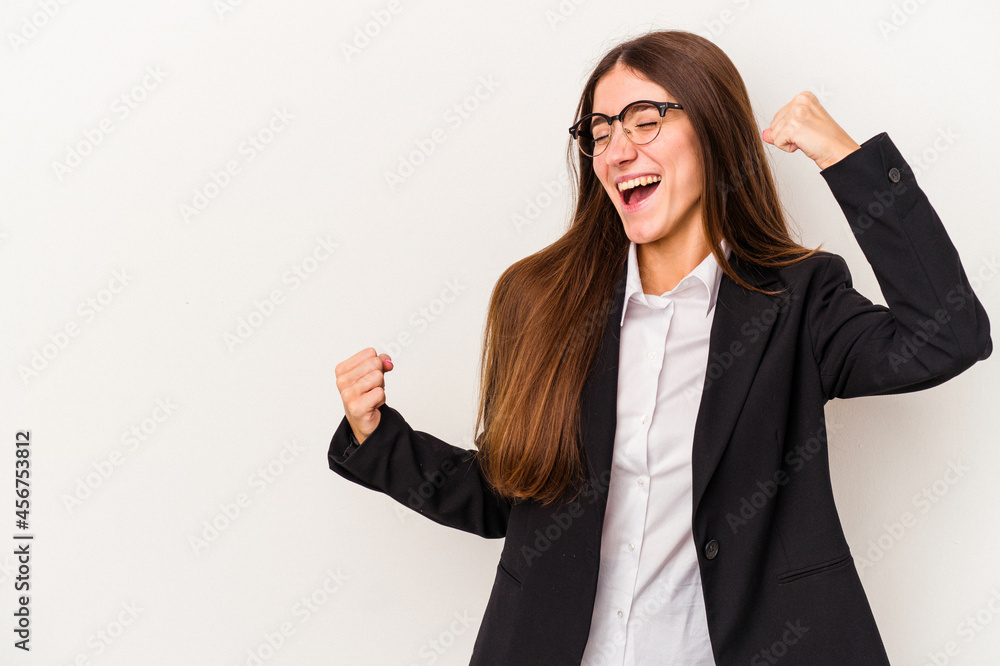 Young caucasian business woman isolated on white background raising fist after a victory, winner concept. Young caucasian business woman isolated on white background raising fist after a victory, winner concept.