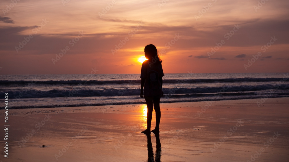 Smile Freedom and happiness silhouette woman on beach Summer travel vacation concept Traveler asian teen girl standing on beach at sunset or sunrise in Phuket Thailand