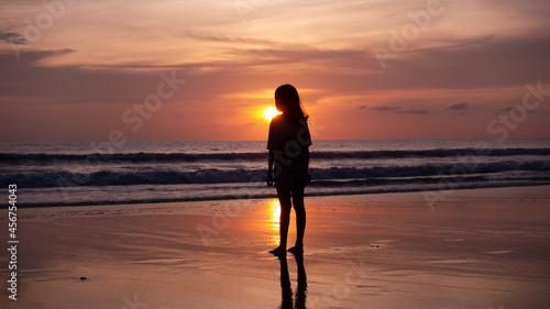 Smile Freedom and happiness silhouette woman on beach Summer travel vacation concept Traveler asian teen girl standing on beach at sunset or sunrise in Phuket Thailand