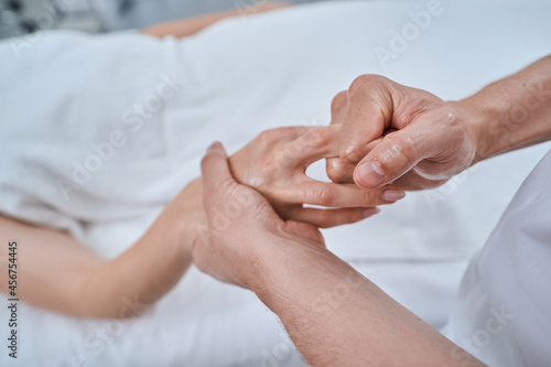 Spa client getting a hand reflexology massage