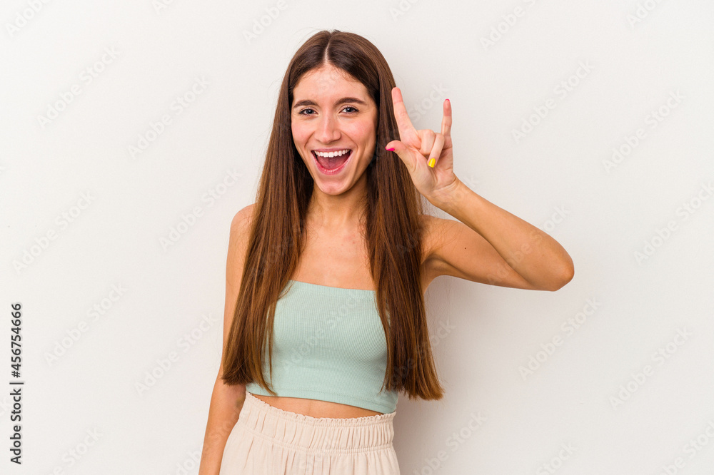 Young caucasian woman isolated on white background showing a horns gesture as a revolution concept. Young caucasian woman isolated on white background showing a horns gesture as a revolution concept.