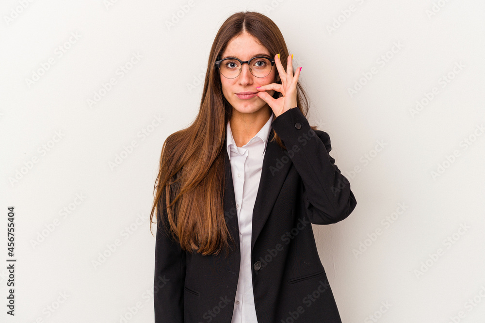 Young caucasian business woman isolated on white background with fingers on lips keeping a secret. Young caucasian business woman isolated on white background with fingers on lips keeping a secret.