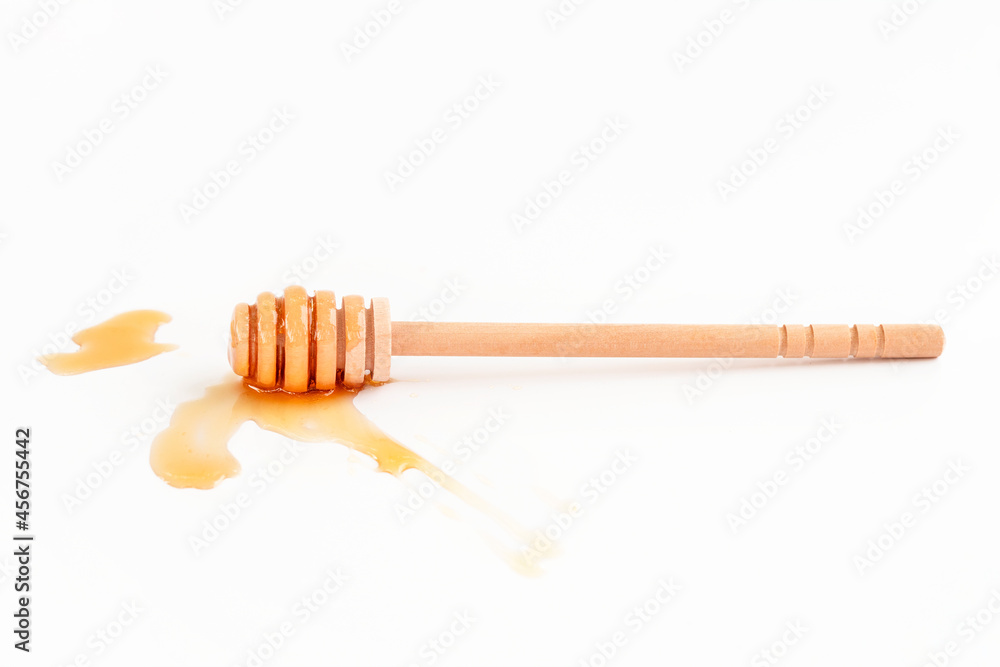 Honey dipper and honey drop on white background Honey dipper and honey drop on white background