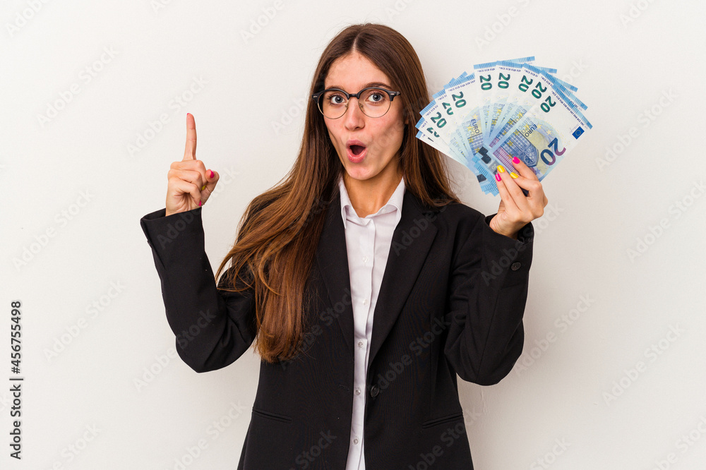 Young caucasian business woman holding banknotes isolated on white background having some great idea, concept of creativity. Young caucasian business woman holding banknotes isolated on white background having some great idea, concept of creativity.