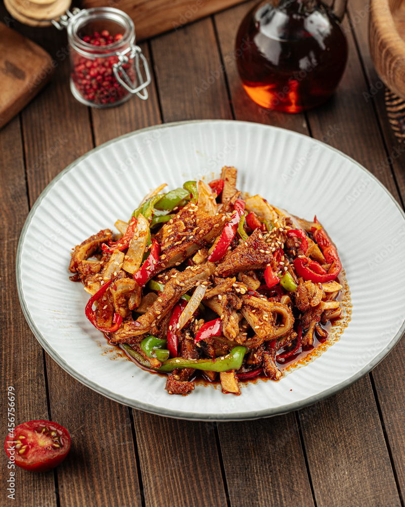 Asian cuisine roasted meat with peppers and sesame seeds