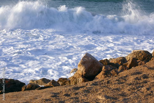 Sea foam in the rays of the sunset.