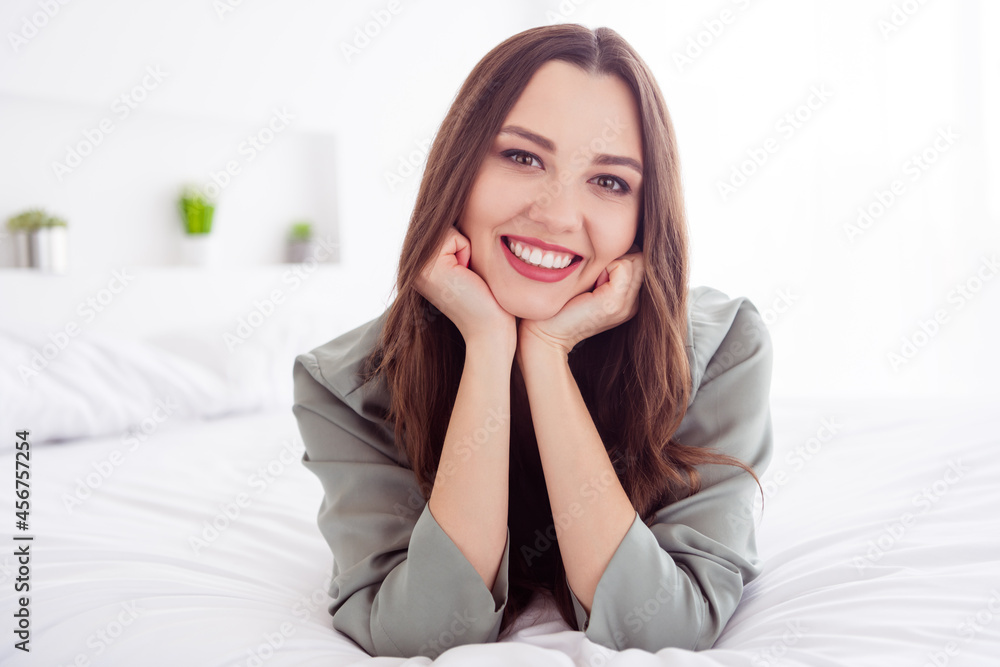 Portrait of attractive cheerful healthy girl lying on bed resting free spare time at home house light white interior Portrait of attractive cheerful healthy girl lying on bed resting free spare time at home house light white interior
