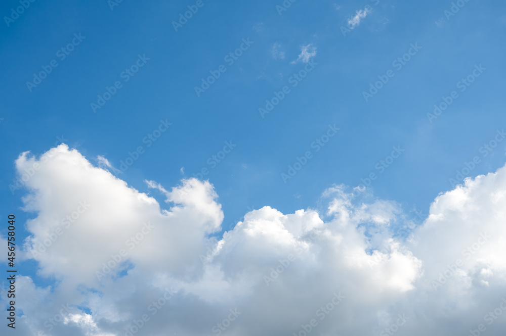 Blue sky with large white clouds in the bottom of the frame. Blue sky with large white clouds in the bottom of the frame.