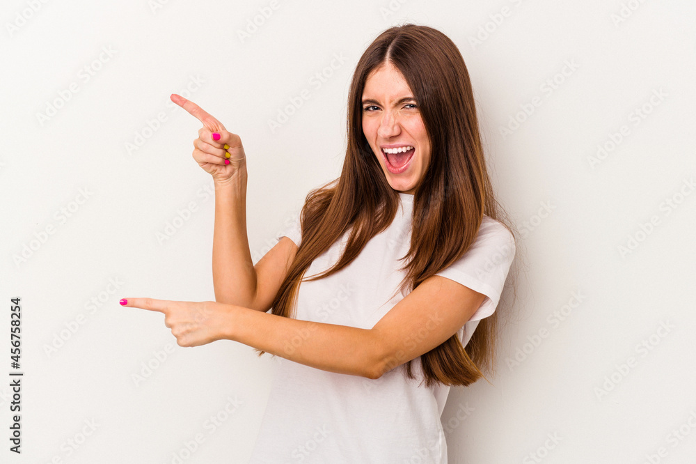 Young caucasian woman isolated on white background pointing with forefingers to a copy space, expressing excitement and desire. Young caucasian woman isolated on white background pointing with forefingers to a copy space, expressing excitement and desire.