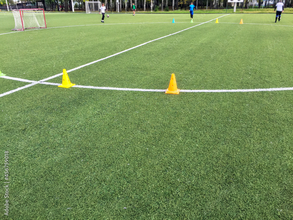 training of athletes on a football field with artificial turf