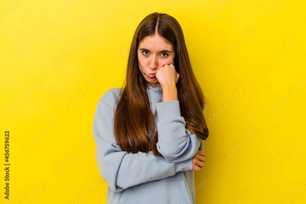 Young caucasian woman isolated on yellow background who feels sad and pensive, looking at copy space. Young caucasian woman isolated on yellow background who feels sad and pensive, looking at copy space.