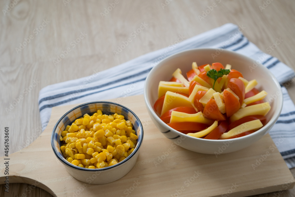 dish decoration with tomato, cheese and corn on a cutting board