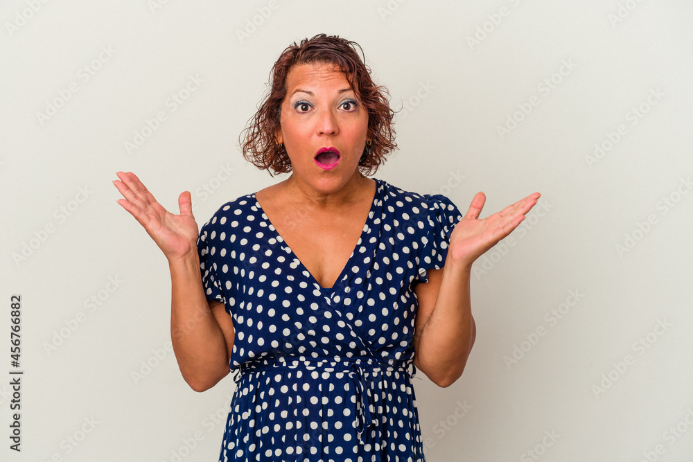 Middle age latin woman isolated on white background surprised and shocked. Middle age latin woman isolated on white background surprised and shocked.