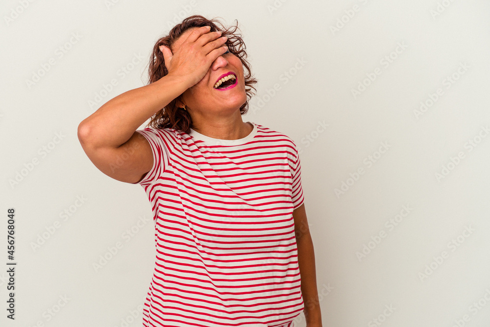 Middle age latin woman isolated on white background laughs joyfully keeping hands on head. Happiness concept. Middle age latin woman isolated on white background laughs joyfully keeping hands on head. Happiness concept.