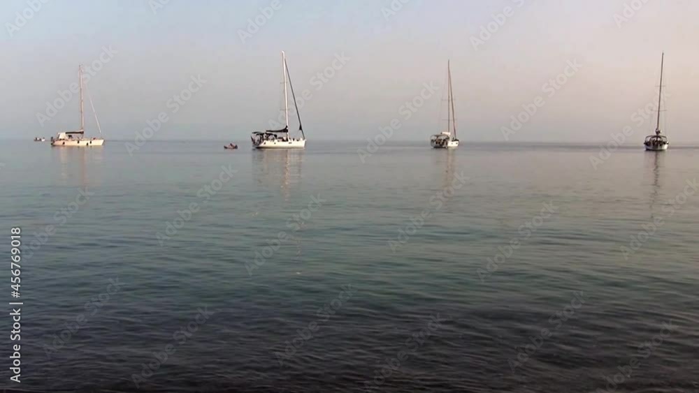 Serene evening in the bay: beachfront and harbor’s mole Serene evening in the bay: beachfront and harbor’s mole
