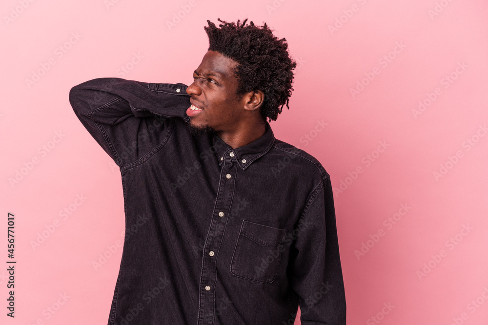 Young african american man isolated on pink background tired and very sleepy keeping hand on head. Young african american man isolated on pink background tired and very sleepy keeping hand on head.