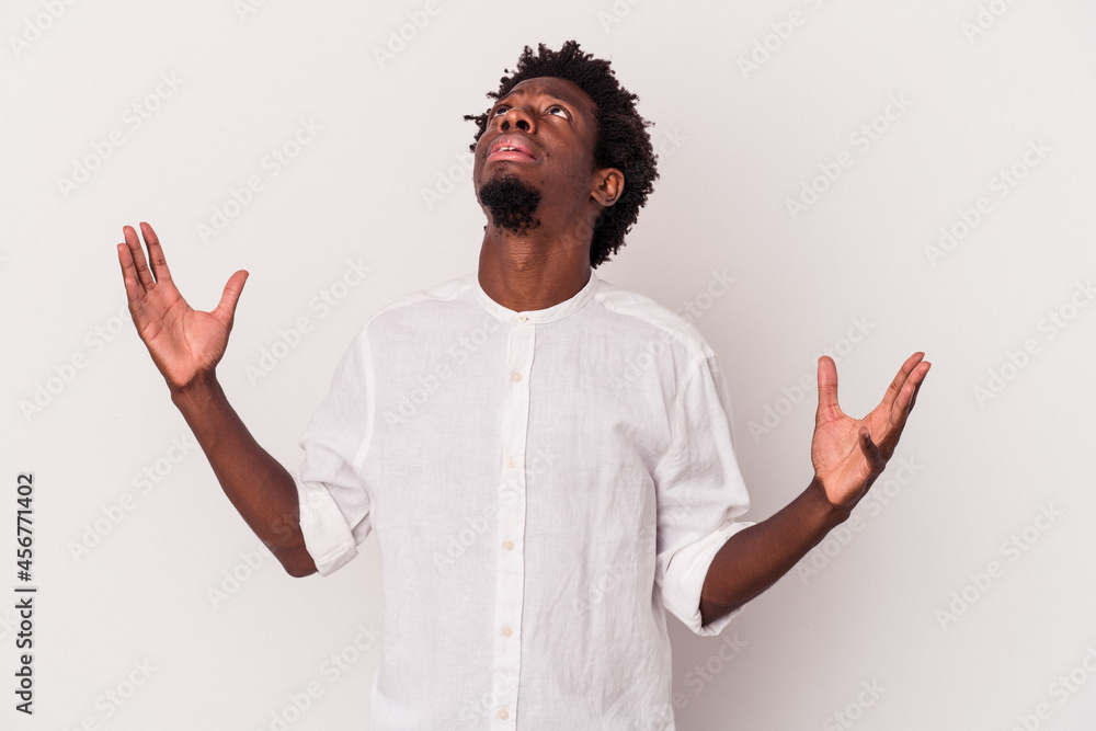 Young african american man isolated on white background  screaming to the sky, looking up, frustrated.