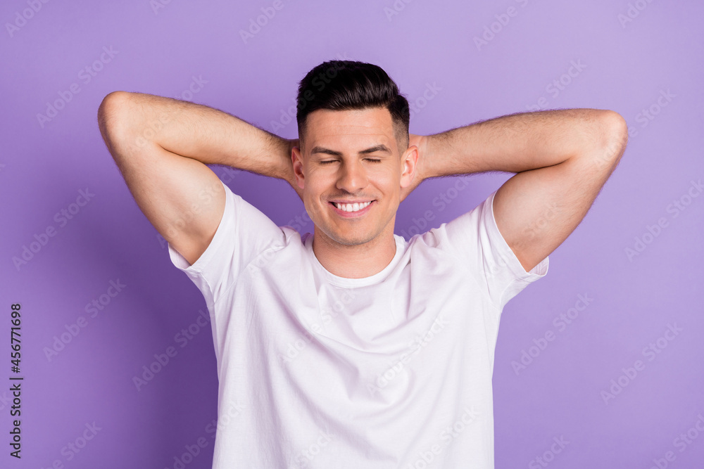 Top above high angle view photo of young man happy smile hands behind head dream sleep relax isolated over purple color background Top above high angle view photo of young man happy smile hands behind head dream sleep relax isolated over purple color background