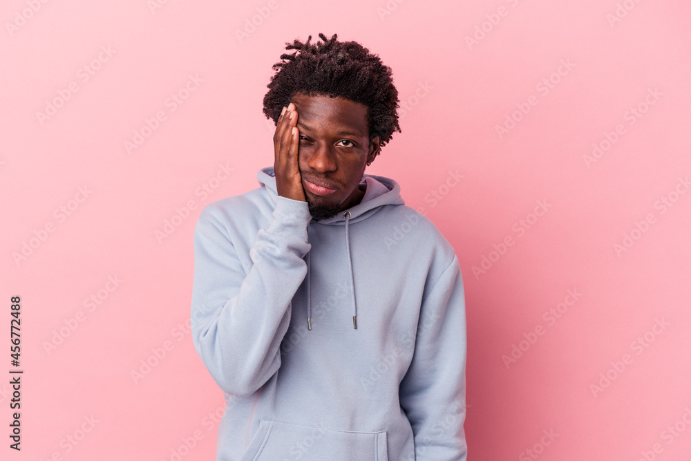 Young african american man isolated on pink background who feels sad and pensive, looking at copy space. Young african american man isolated on pink background who feels sad and pensive, looking at copy space.