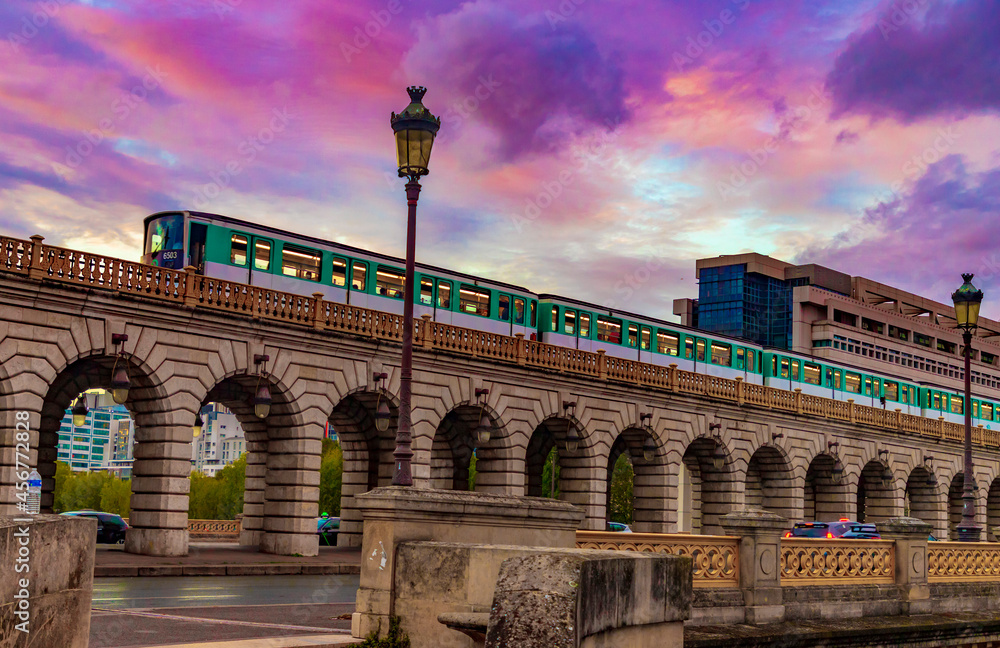 metro train on bridge - sunset time in paris city