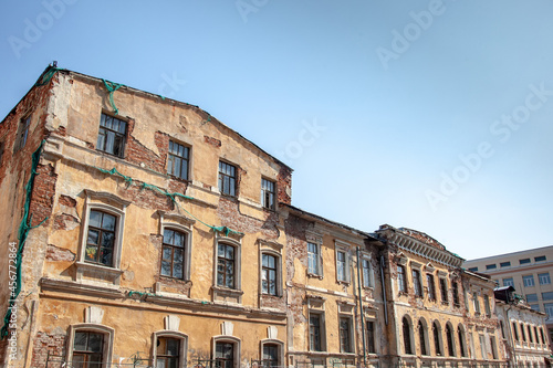 old city building, with a damaged and dilapidated facade