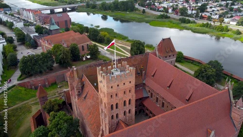 Aerial panning view on Castle fortifications of the Teutonic Order in Malbork from East. Malbork Castle is the largest castle in the world measured by land area.