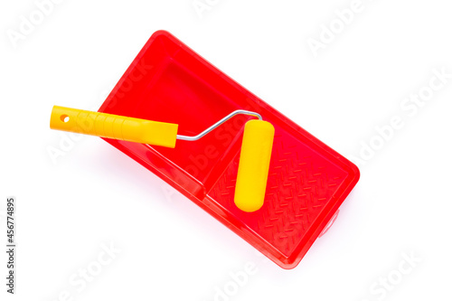 Paint roller and tray isolated at white background. Construction tool
