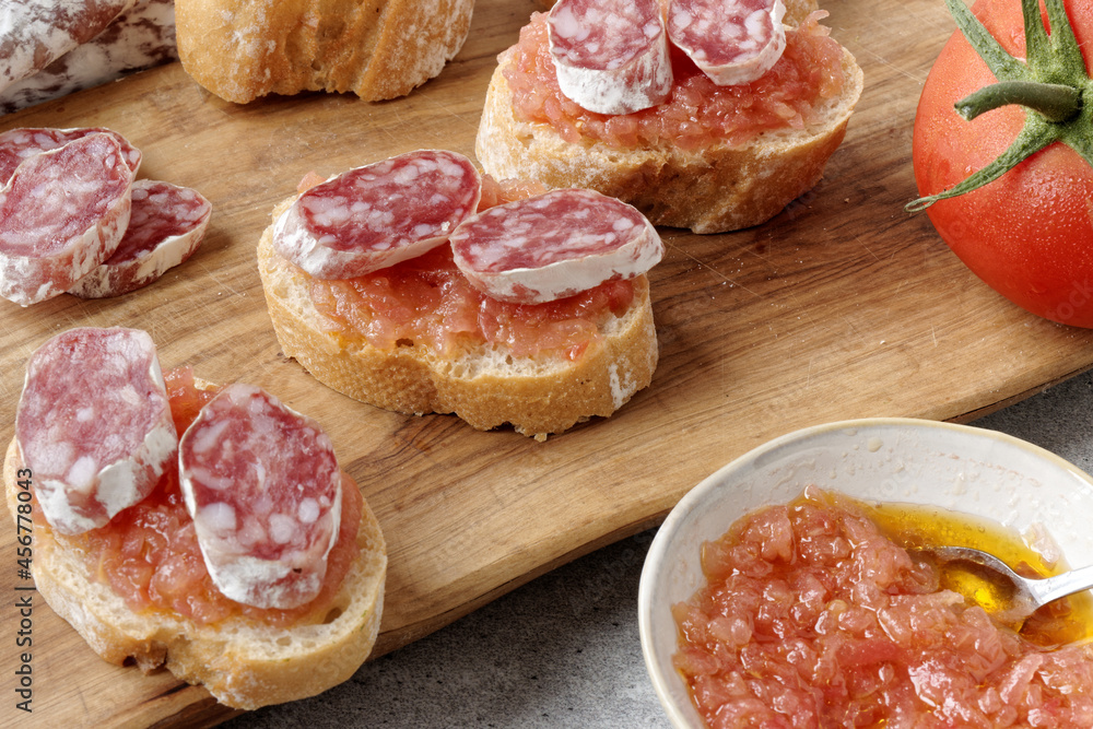 Bread slices with tomato and olive oil paste (Pa amb tomaquet) and sliced fuet. Bread slices with tomato and olive oil paste (Pa amb tomaquet) and sliced fuet.