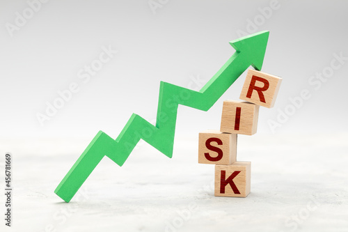 High risk. Green up arrow and RISK cubes on gray background