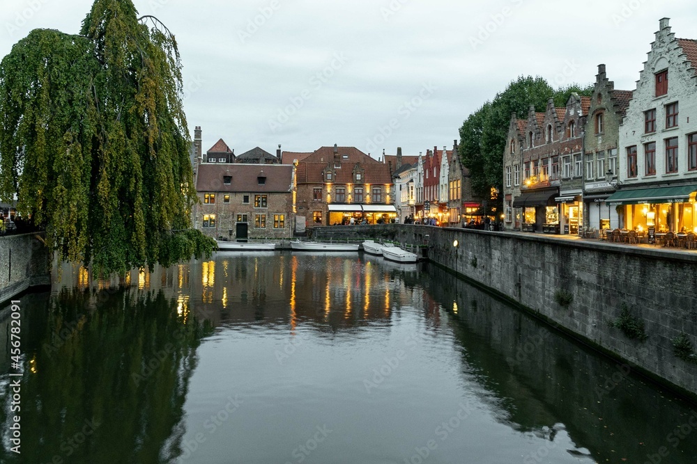 Bruges, Belgium. September 30, 2019: Dock of the rosary and reflections in the water of the lights.