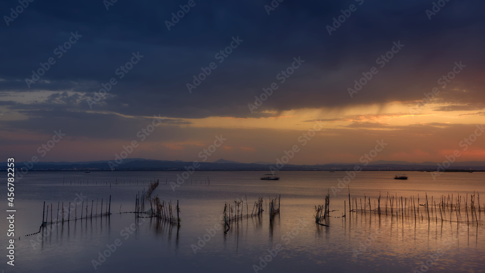 Albufera, Valencia lagoon in Spain. Close to sunset time with an impressive cloudy sky and beautiful colors.
