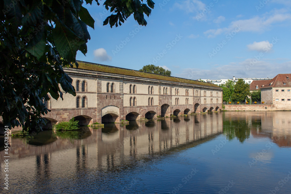 Beautiful view of the Barrage Vauban, a defensive city dam structure on the Ill River (also called the Grande Écluse), in the city of Strasbourg, France.
