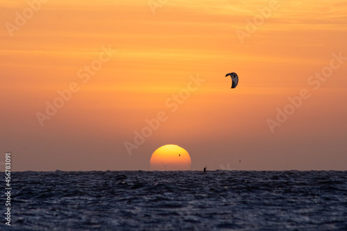 Sunset com kitsurf no mar. Pôr do sol na praia de Barra Grande, litoral do Piauí, nordeste brasileiro. photo